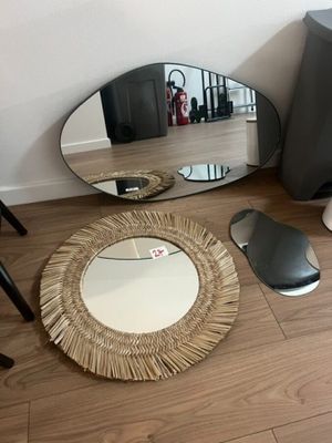 a mirror that is sitting on the floor next to a speaker
