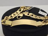 a close up of a box with a gold bracelet on it