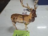 a glass deer on a table with a price tag on it