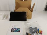 a laptop computer sitting on a table next to a box