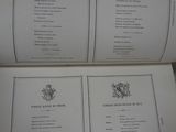 two pages of a book with a picture of a coat of arms on it