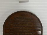 an image of a plaque on a white surface with a number on it