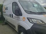 a white van parked in front of a building