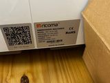 a cardboard box sitting on the floor next to a box with a qr code on it
