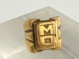 a gold ring with the letter e on it