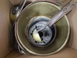 a metal bowl with a spoon in it and a piece of butter in it