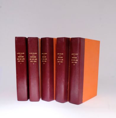 three red books are stacked on top of each other on a white surface