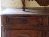 a wooden dresser with a mirror on top of it
