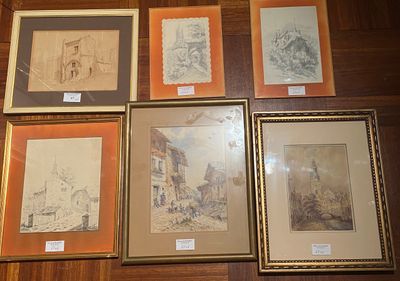 a lot of framed art on the floor of this room