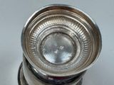 a silver cup that is sitting on a table