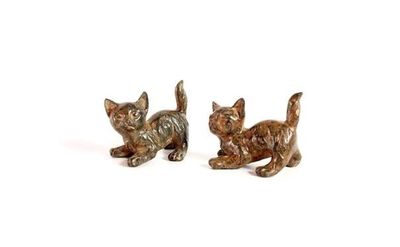 pair of bronze cat figurines on a white background