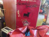 a red sign that says rodeo show on the side of a building