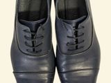 pair of black leather shoes with laces on them on a white background