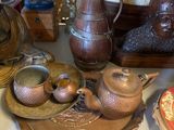 many different types of vases on display on a table