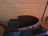 a black bag and a brown bag on a shelf