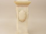 a white marble clock with a lion head on the front of it