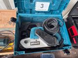 a blue tool box with tools in it on the floor