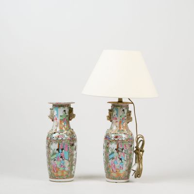 pair of chinese vases with handles and a lamp on a white background
