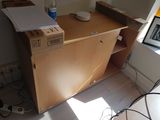 a box that is sitting on top of a wooden cabinet