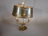 a lamp that is sitting on a table with a bird on top of it