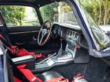a blue car with a red seat belt and a steering wheel