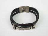 a black leather bracelet with two silver beads and a metal clasp