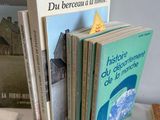 a lot of books on a table with pictures on it