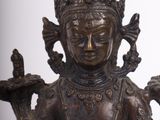 a statue of a woman holding two birds in her hands