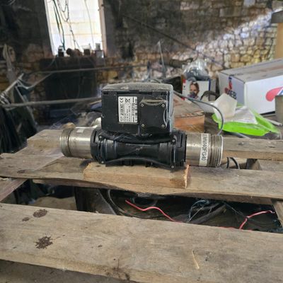 a small pump sitting on top of a wooden pallet