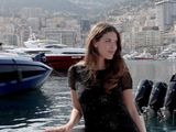 a woman that is standing on a boat in the water