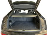 the back of a car with the trunk open and the seats down