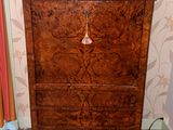 a wooden chest of drawers with a clock on top of it