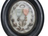 a picture of a picture of two medals in a black frame