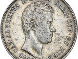 Gros plan sur une pièce de monnaie portant le visage d'un homme