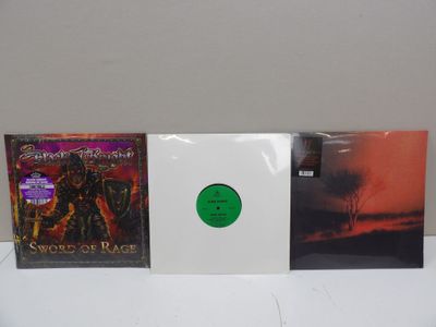 three cd ' s with a green disc on top of them