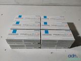 four boxes of dental care products sitting on top of a table