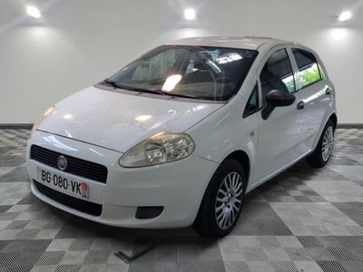 a picture of a small white car parked in a garage