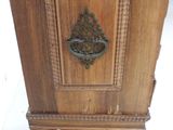 a wooden cabinet that has a metal handle on it