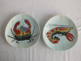 two plates with crab and lobster designs on them