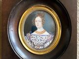 an old picture of a woman in a floral dress in a wooden frame