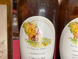 three bottles of wine sitting on a table with a red cloth