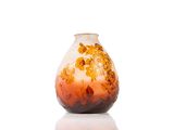 a vase with a floral design on it on a white surface