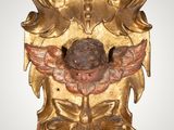 an image of a gold mask with a bird on it