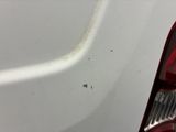 a close up of a car ' s bumper with a small hole in it