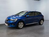 Une voiture bleue est garée dans une pièce aux murs blancs.