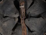 an old helmet with a leather band and a leather strap