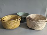 three woven baskets sitting on top of a table next to each other
