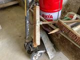 un seau rouge posé sur une charrette dans un garage