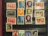 an old picture of a collection of stamps on display in a glass case