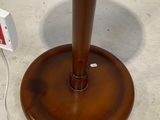 a wooden table with a lamp on it next to a remote control
